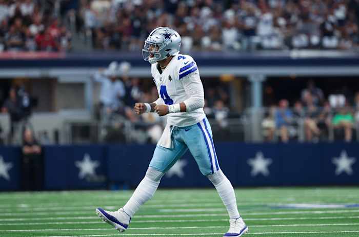 Dallas Cowboys quarterback Dak Prescott reacts after throwing a touchdown pass.